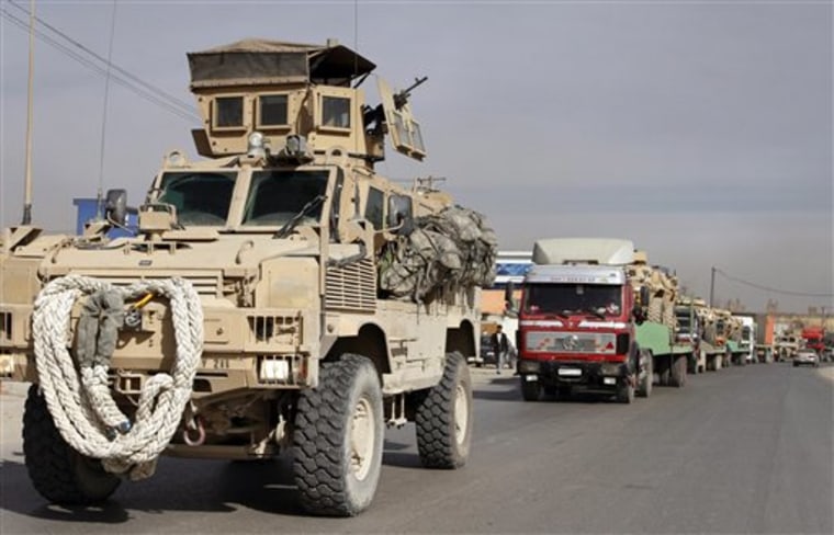 A U.S. armored personal carrier vehicle escorts a convoy of trucks carrying U.S. equipments in Kabul, Afghanistan, in January. Criminal investigators are examining allegations that Afghan security firms have been extorting as much as $4 million a week from contractors paid with U.S. tax dollars. 